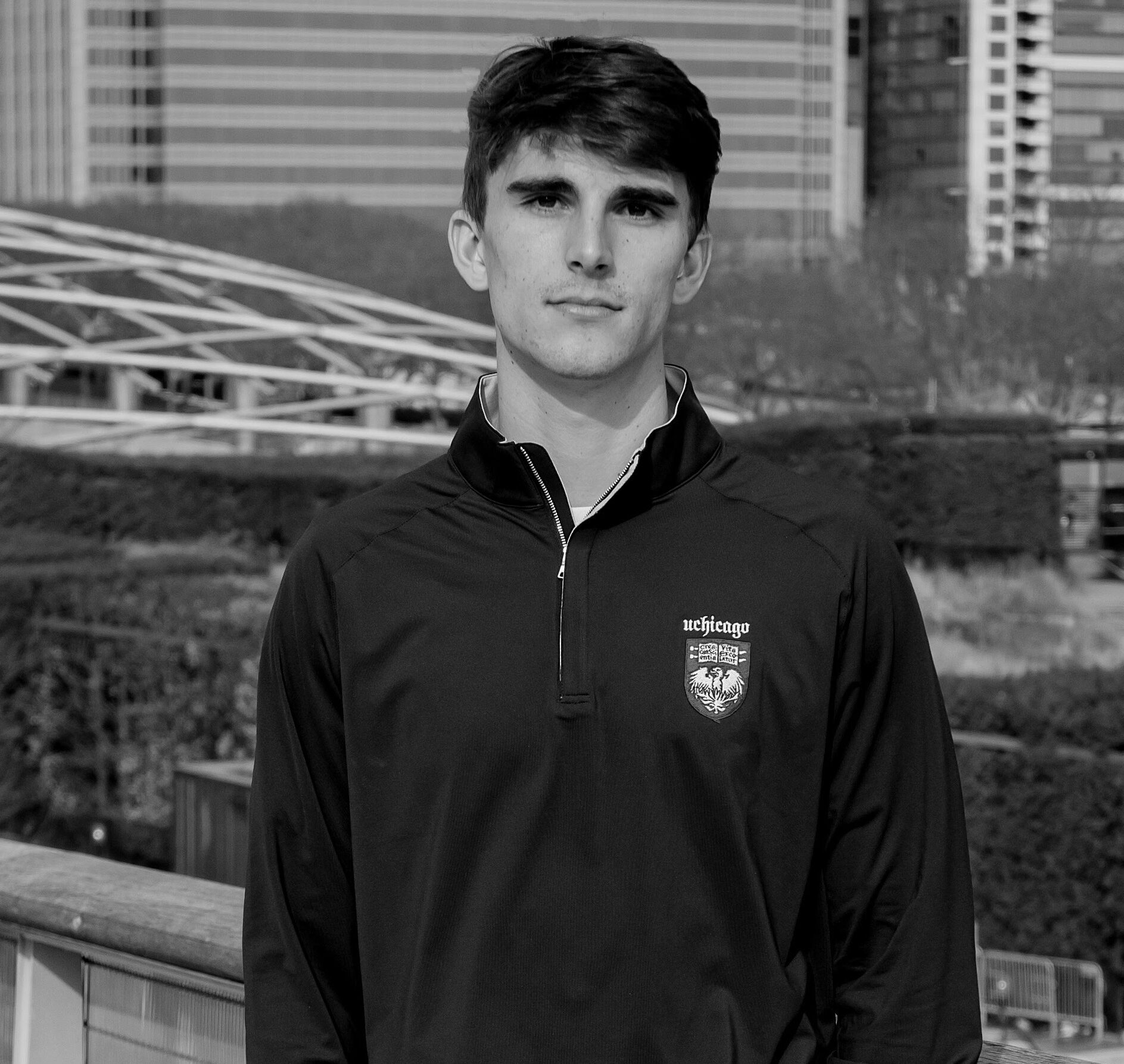Luke Johnson, Communications and Outreach Coordinator for CIRCE, in black and white, UChicago quarter zip